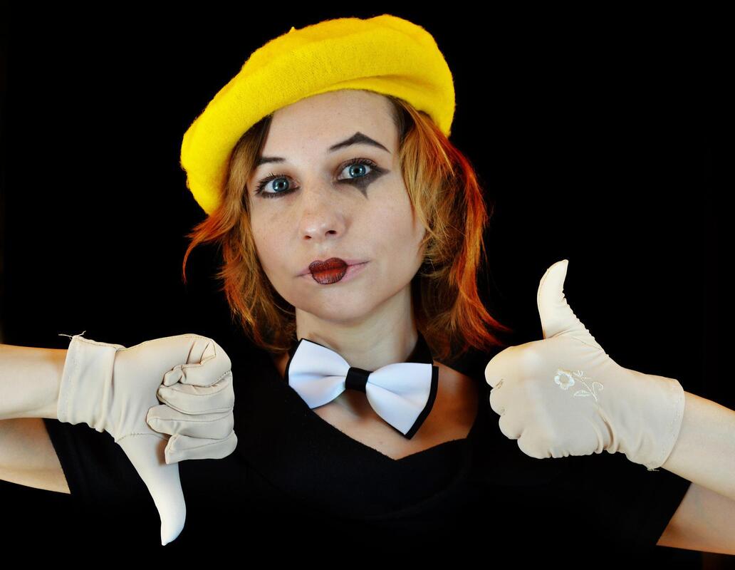 Female mime giving thumbs up and thumbs down