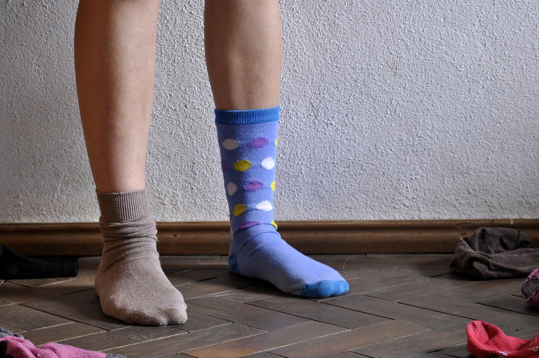 A person wearing two distinctly different socks